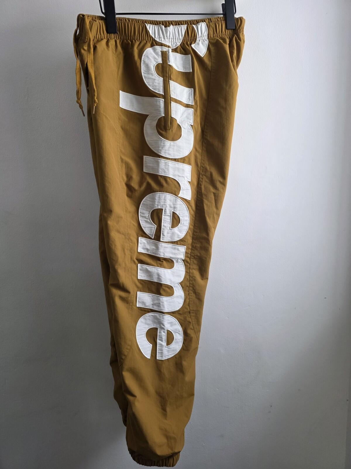 SS21 Supreme Spellout Track Pant Dark Gold Size M