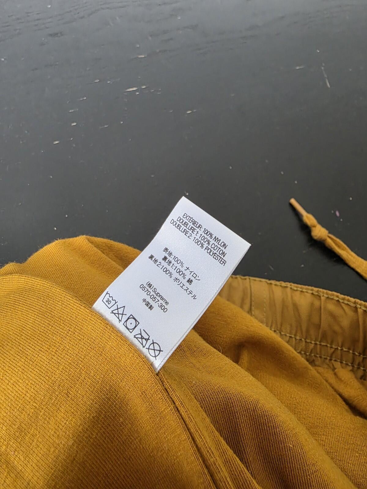 SS21 Supreme Spellout Track Pant Dark Gold Size M