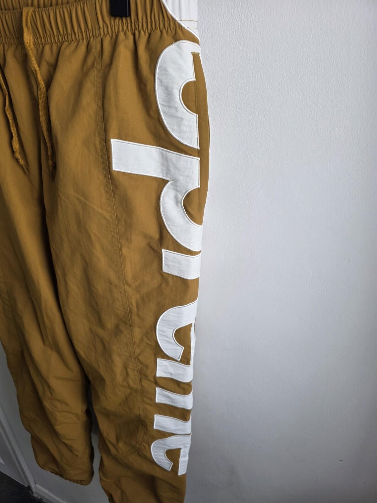 SS21 Supreme Spellout Track Pant Dark Gold Size M