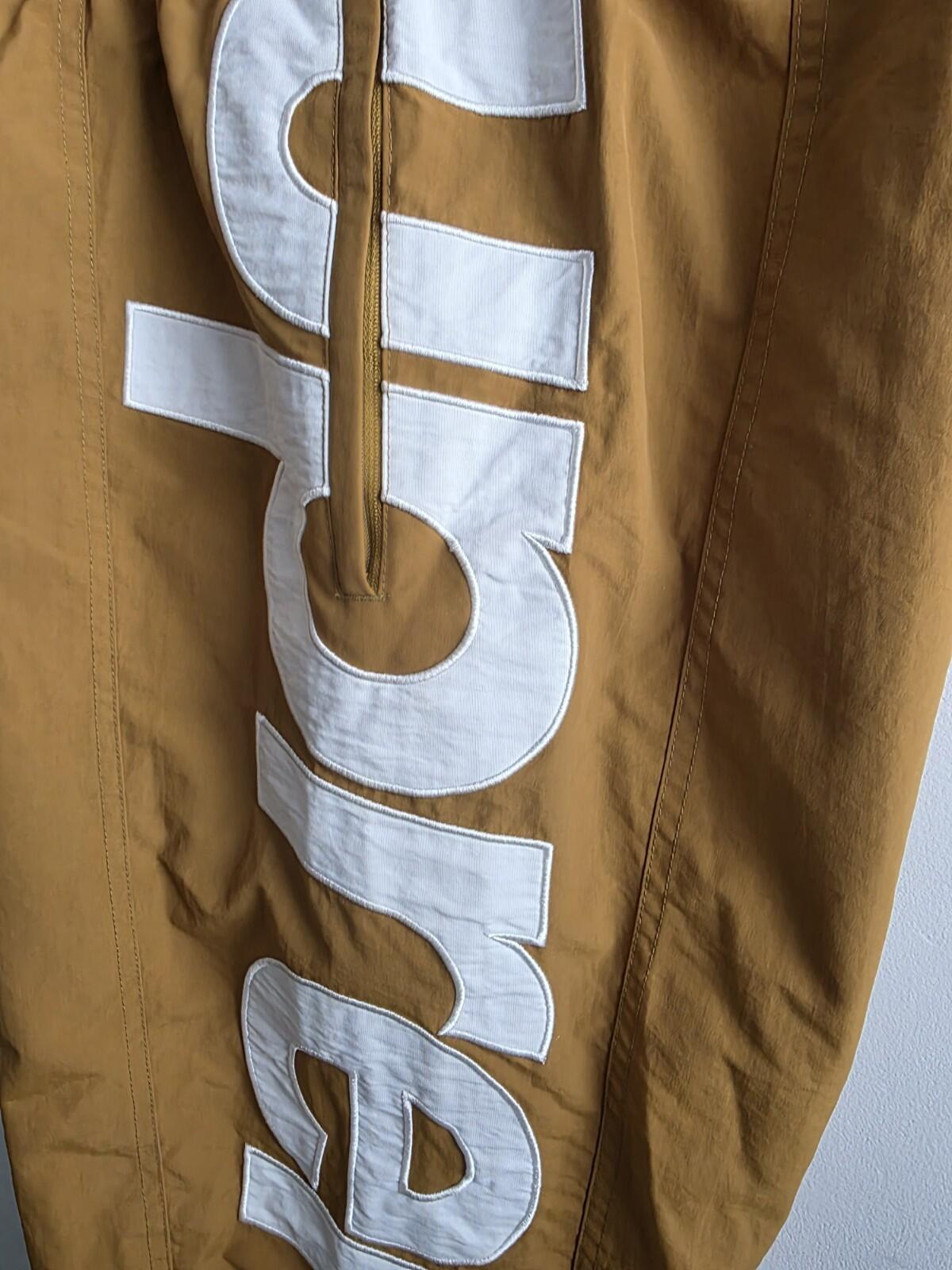 SS21 Supreme Spellout Track Pant Dark Gold Size M