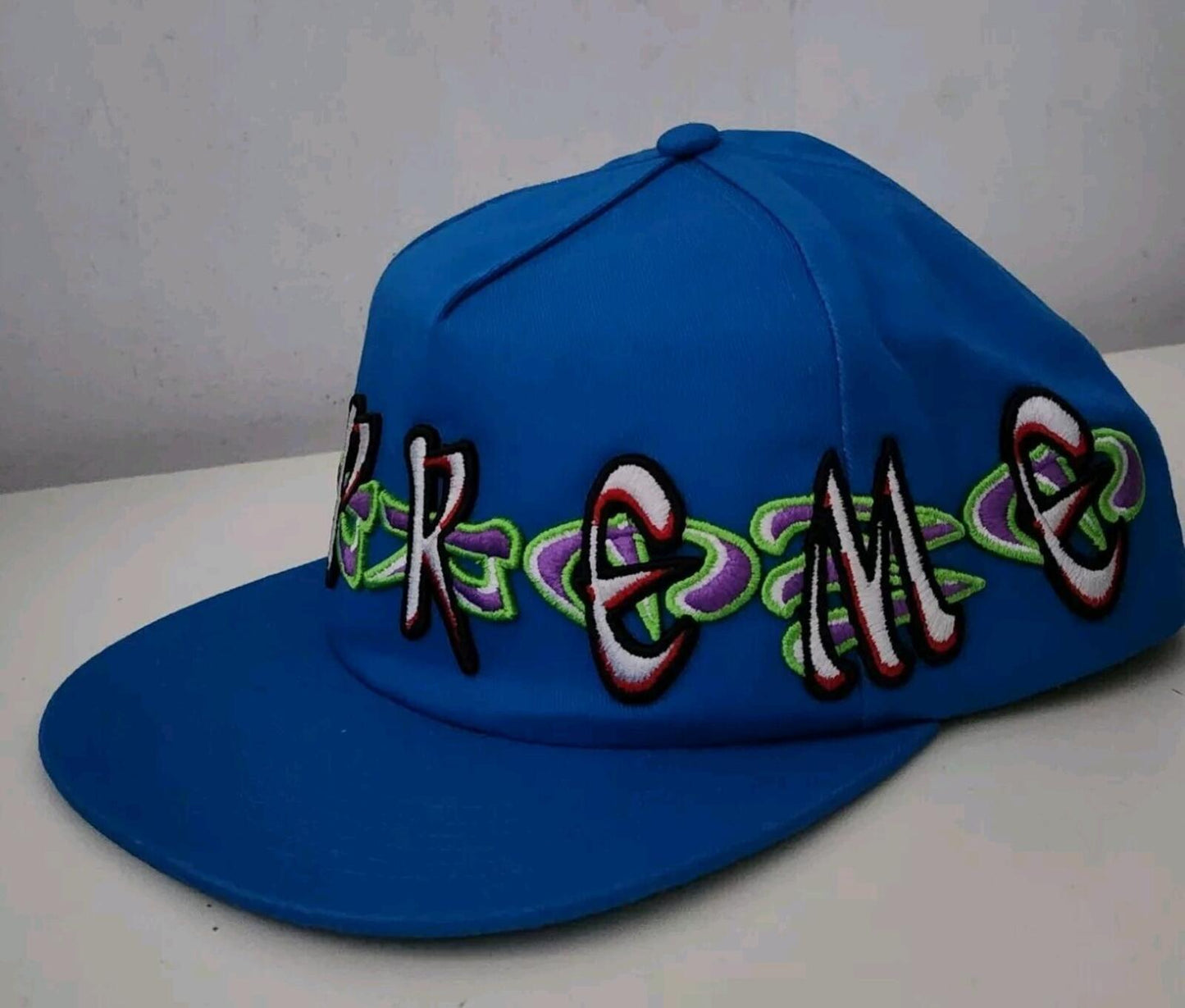 FW23 Supreme AOI Spellout 5-panel blue hat cap embroidered artwork by AOI