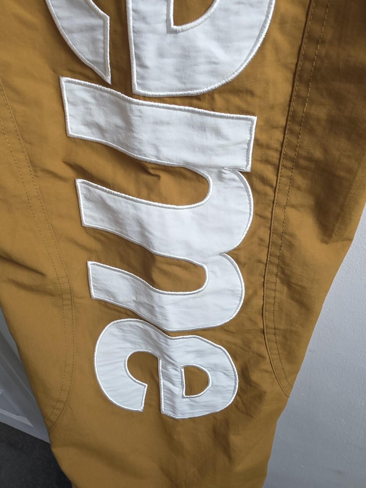 SS21 Supreme Spellout Track Pant Dark Gold Size M